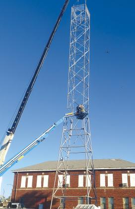 Angie Gentry photo The 102ft tall Chrysler Tower returned to its home. The bottom portion was installed on Monday, Oct. 20 and the top portion of the tower was lifted by crane to the top on Tuesday morning. The letters are still being restored, neon added, more concrete poured, electrical and security cameras added, and eventually the brick back wall and exterior brick perimeter walls will be added along with a parking lot. Completion is expected to be around April 2026