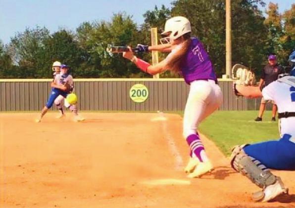 Kinzie Williams watches the balls into the dirt. courtesy photo