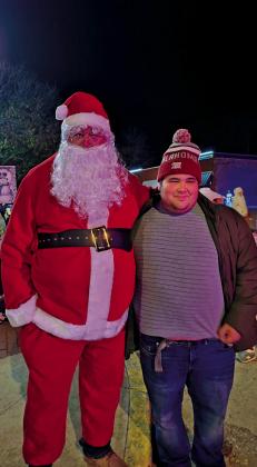 Santa visits Depew, enjoying the parade and hot chocolate. Michael Hall gets a photo with Santa.