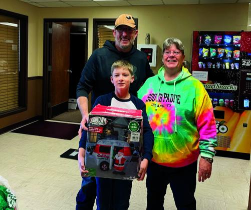 Oliver Grossman had a collection of more than a dozen holiday inflatables, including a twentyfoot Santa, that he donated to the city to add to the decorations around town. Oliver Grossman and his father Justin, along with Dena Hinshaw from city hall courtesy photo