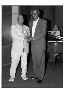 Odell Alexander presents theCelebrating Excellence Award to Sherman Lewis. courtesy photo