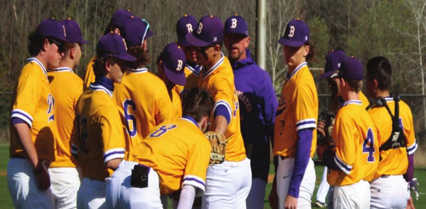Coach Avery gives his team a pep talk between innings. Rebecca Langston photo