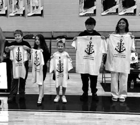 The GoldStandard represents the core values instilled by the Bristow Athletic Dept. The trait for this game was OWNERSHIP. Each student will represent this trait at their sites. From left, Jacob Plum, Collins Elementary, Violet Gerszienkorn, Collins Elementary, Kolby Barnett, Edison Elementary, Hilario Martinez, Bristow Middle School, and Jaiyana Simmons, Bristow High School. courtesy photo