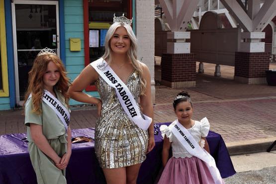 From left, Cora Pride, Little Miss Tabouleh, Erin Sellers, Miss Tabouleh, and Arianna Arredondo, Tiny Miss Tabouleh, talks with visitors at the Tabouleh Festival
