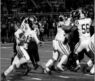Rebecca Langston photo Ryder Goodwin attempts a first down while the offense line holds the Cardinals back.