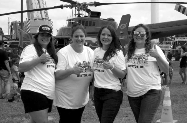 Kylie Thomas, Ashlee Price, Rebecca Evans, and Jamie Braden at Touch-A-Truck Bristow 2025 in front of Survival Flight 12 and Bennett Steel’s crane. courtesy photo