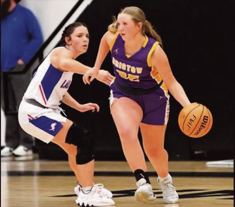 Tinlee Roberts takes the ball down court.