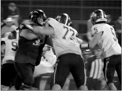 Gavin Shagena, Christopher White and Jack Johnson play defense.