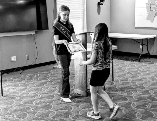 Riley Braden handing out winners certificates.