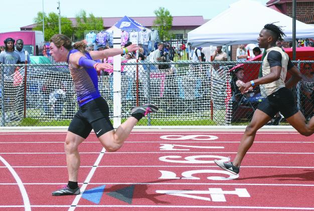 Bristow 200 meter state champion, Gage Spencer, hits the fniish line with style.