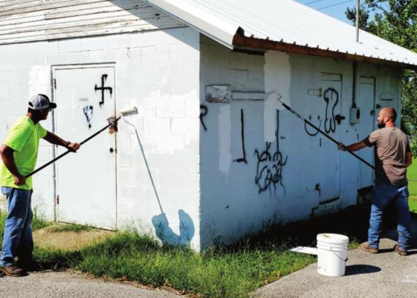 From left:, city workers Jeramie Caldwell and Joey Gasperini cleaning the graffiti off the walls. courtesy photo