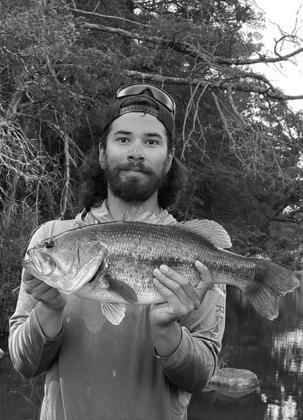 Branden Davis with a largemouth bass caught at the Blue River.