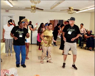 Milton Harper leads a group dance.