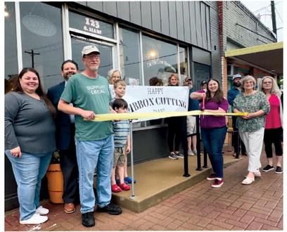 Mayor Kris Wyatt, Jeryn Fletcher, John Tidwell, Chelsey Wilson, Frank and Melody Wolbert, owners, Margaret Foster (holding ribbon) mother and shop helper, (in random order) friends, Tom and Dana Dooley, Mitchell Smith, Tristan and Samuel Maples, and Dale Bird, local artisan, vendor and friend.
