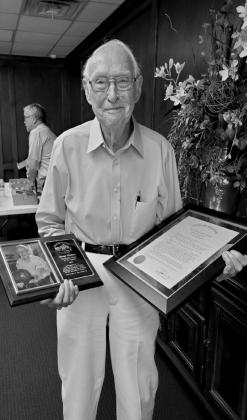 George Krumme holds the plaque and Proclamation given to him by the City of Bristow. courtesy photo