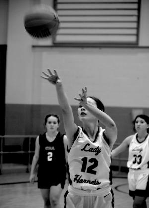 Lauren Carrie shoots a free throw with Samantha Peeler watching closely. courtesy photos