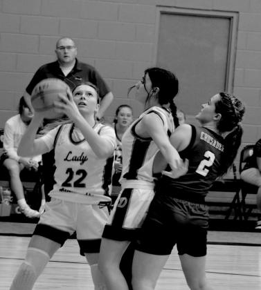Ashley Hall goes for a shot while Samantha Peeler blocks.