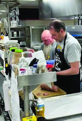 courtesy photo The Bristow Noon Lions Club held its delicious pancake breakfast, Saturday, at the Edison Cafeteria. Shown is member David Barnett cooking pancakes and Mike Widdoes and David David Baker.
