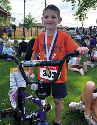 Cruz Batschelett, of Bristow, age 7, was very happy to win a bike after the Wildflower Run .