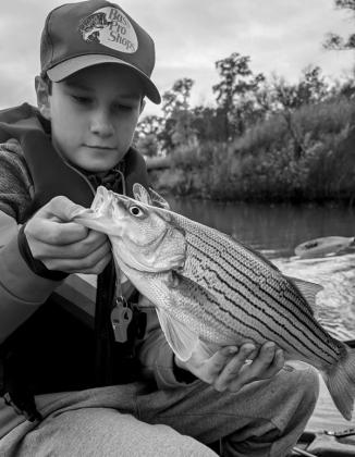 Michael S. with a striped bass hybrid caught at Kaw Lake. courtesy photo