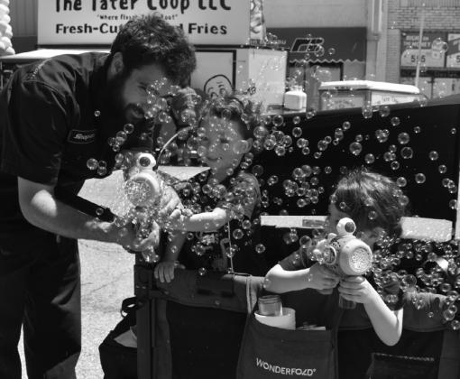 These kids enjoyed creating bubbles at the Tabouleh Fest on May 9, 2026. Lots of kids played on inflatables and drew figures in chalk on the street.