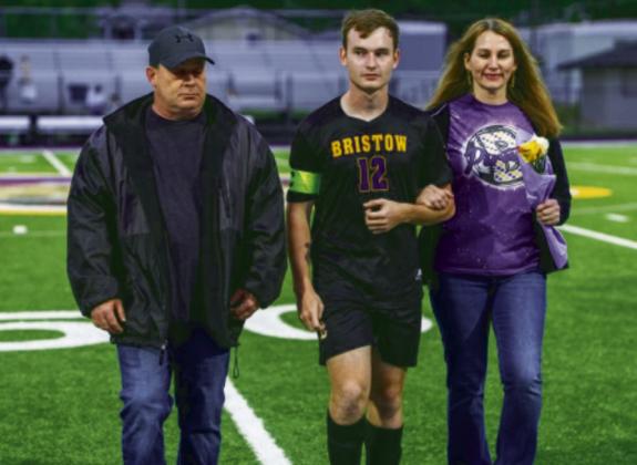 Brayden Dearman being escorted Jason and Julie Dearman