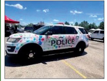 Children had fun placing colorful hand prints all over this Bristow Police car. courtesy photo