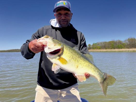 Milton Cade with a largemouth bass caught at Dripping Springs Lake.