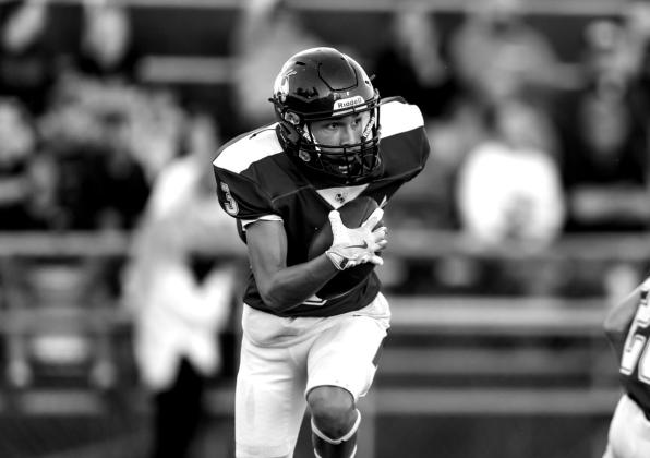 Wyatt Osburn has possession, going for yardage.