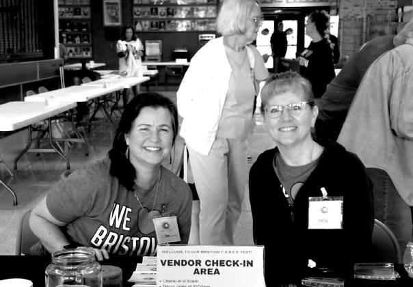 Pam and Kelly, of Cornerstone Church, happy to serve as they sign in vendors and guest.