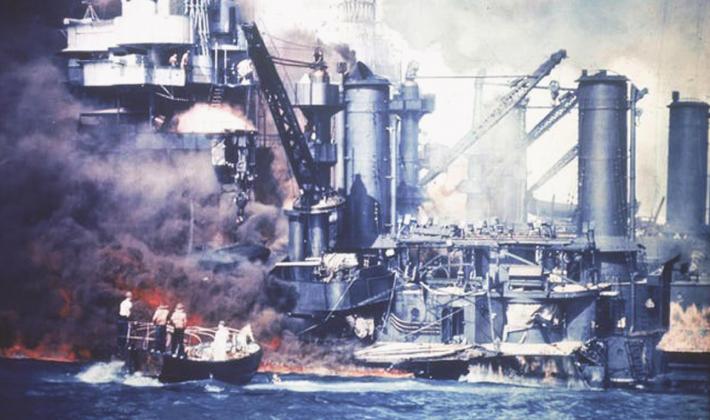 A small boat rescues a USS West Virginia crew member from the water after the Japanese bombing of Pearl Harbor. courtesy photo