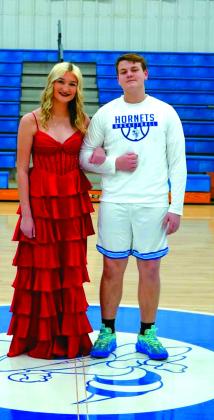 Sophomore attendant Kylee Smith escorted by Reverend Hoover.