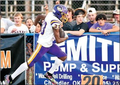 Caleb Alexander runs past the Bristow fans en route to a touchdown in the first half.