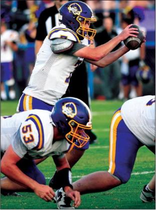 Jon Montgomery takes the snap and Kanaan Lasater prepares to block.