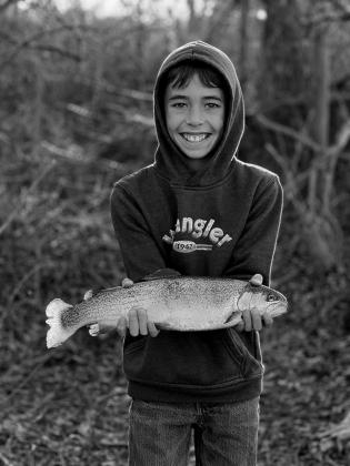 Cooper Collins with a rainbow trout caught at Perry CCC