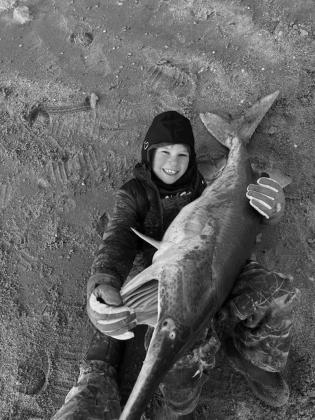 Laken Snapp with a paddlefish caught at Kaw Lake.