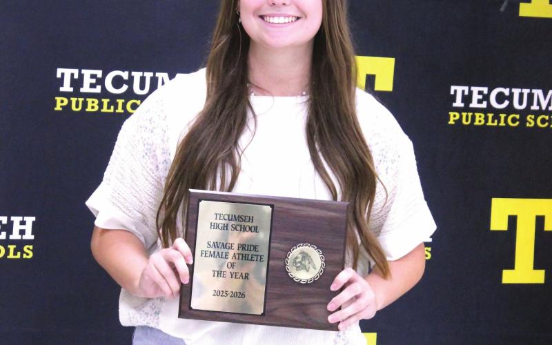 Senior Maggie Wilson poses with her Savage Pride Female Athlete of the Year plaque during the THS Athletic Awards on May 18.