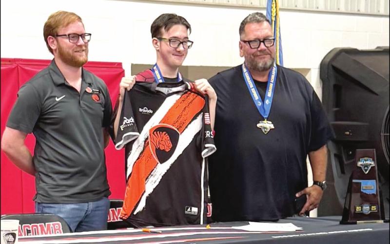 Macomb senior Jasson Harris-Green, center, shown with ECU Esports Director Cody Soden, left, and guardian Harvey Kliewer, right.