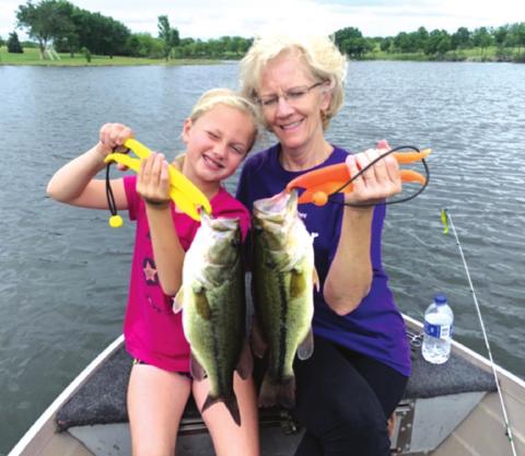 Eight year old Elizabeth Fagg was fishing on a private lake when a good sized fish bit her hook. The line hung up on a suberged tree and then it magically came free. Elizabeth then reeled in two bass at the same time on her lure. One bass was 3 lbs. and the other 3.4 lbs. courtesy photo