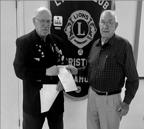 District Governor David Wooddall presents Marland Armitage with an awrd for 50 years of service.