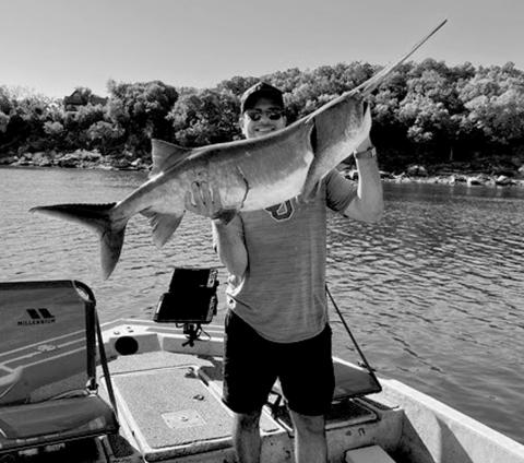Kyle Pfau with a paddlefish caught at Keystone Lake. courtesy photo