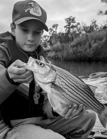 Michael S. with a striped bass hybrid caught at Kaw Lake. courtesy photo