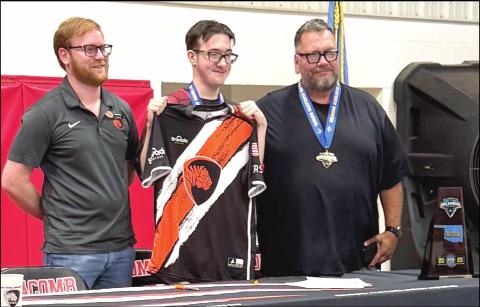 Macomb senior Jasson Harris-Green, center, shown with ECU Esports Director Cody Soden, left, and guardian Harvey Kliewer, right.