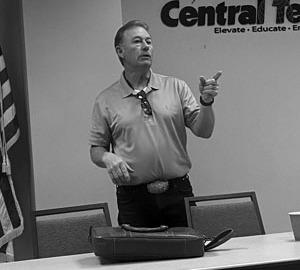 Meteorologist Travis Myer speaks at meeting