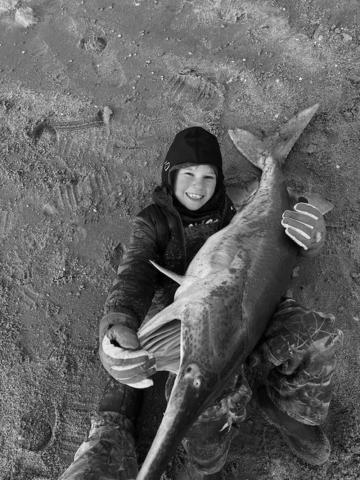 Laken Snapp with a paddlefish caught at Kaw Lake.